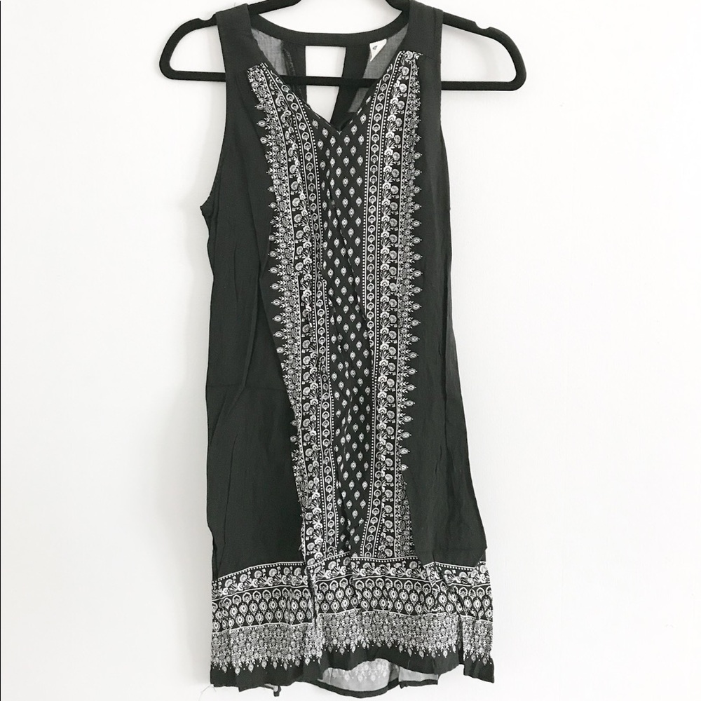 black sleeveless dress with white floral pattern